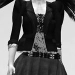 Xue Faith in a power jacket with impressive shoulder pads and a dynamic pleated miniskirt